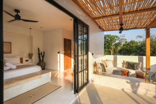 a bedroom with a bed and a couch at Villa Sama Canggu in Canggu