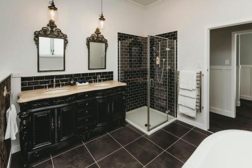 a bathroom with two sinks and a shower at Buller Noire Outstanding in New Plymouth