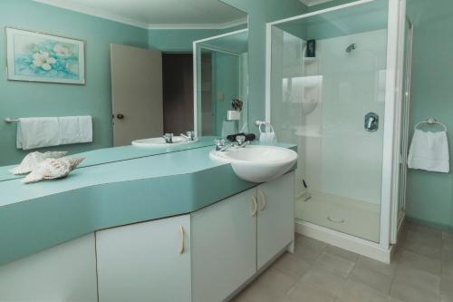 a bathroom with a sink and a shower at Stay At Saddle Row in New Plymouth