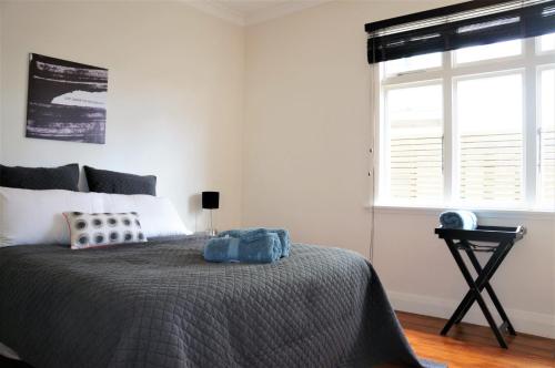 a bedroom with a large bed and a window at The Buller Bungalow You Will Fall In Love in New Plymouth