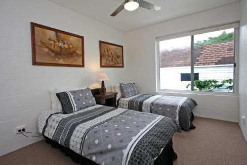 a bedroom with two beds and a window at Quarterdeck 8 in Lennox Head