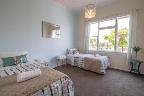 a bedroom with two beds and a window at The Homestead Rural Family Retreat in Sentry Hill