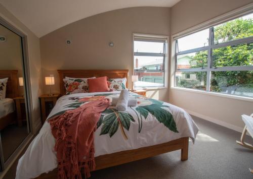 a bedroom with a large bed with a large window at Great Location On Gilbert Central in New Plymouth