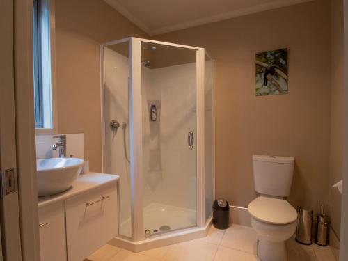 a bathroom with a shower and a toilet and a sink at Great Location On Gilbert Central in New Plymouth