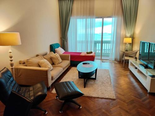 a living room with a couch and a table at Penang Straits Quay Marina Suites By AuroraHomes in Bagan Jermal