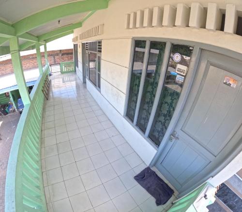 an empty porch of a building with a door at Riverside Homestay Jogja in Yogyakarta