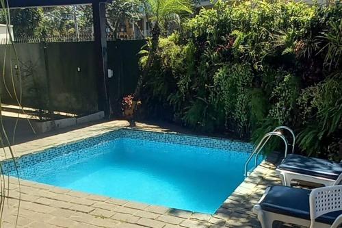 a small swimming pool in a yard with a patio at Casa agradável com Piscina in Sao Paulo
