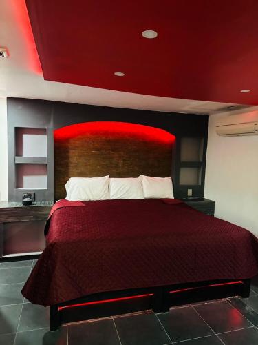 a bedroom with a bed with a red headboard at Ya no tenemos servicio in Mexico City