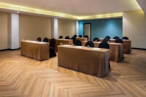 a row of tables and chairs in a room at Holiday Inn Panama Canal by IHG in Panama City