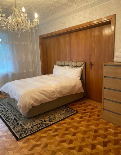 a bedroom with a large bed with a wooden headboard at 2 bedroom apartment close to Kaunas airport in Karmelava in Karmėlava