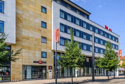 a building on a street with trees in front of it at ibis Heilbronn City in Heilbronn