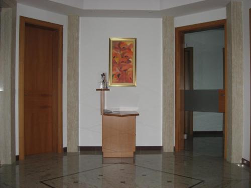 a hallway with two doors and a painting on the wall at Apartmaji in sobe RaMar in Straža