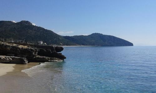 a view of a beach with mountains in the background at Vila Bello in Ksamil