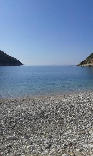 a rocky beach with the ocean in the background at Vila Bello in Ksamil