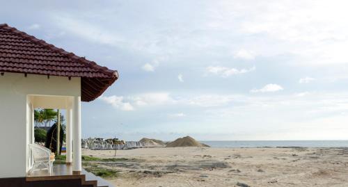 a house on the beach with a view of the ocean at Seclude Kerala, Seaside in Mararikulam