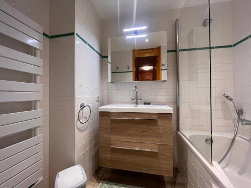 a bathroom with a sink and a tub and a shower at Appartement Méribel, 2 pièces, 5 personnes - FR-1-355-247 in Les Allues