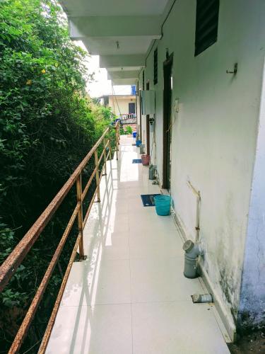 an empty hallway of a building with a fence at Shree Sai Beach Stay in Arambol