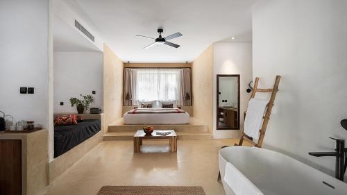 a bedroom with a bed and a tub in a room at South Zhongwei Resort in Zhongwei