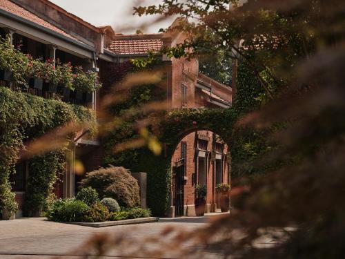 an entrance to a building with plants on it at Capella Shanghai, Jian Ye Li in Shanghai