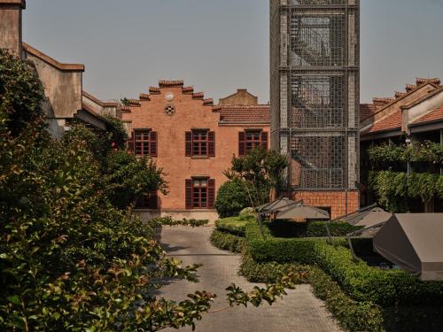 a courtyard with a building with a clock tower at Capella Shanghai, Jian Ye Li in Shanghai