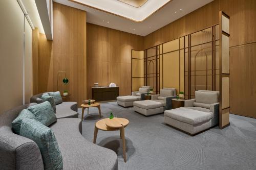 a waiting room with couches and chairs and a table at Grand HiLai Taipei in Taipei