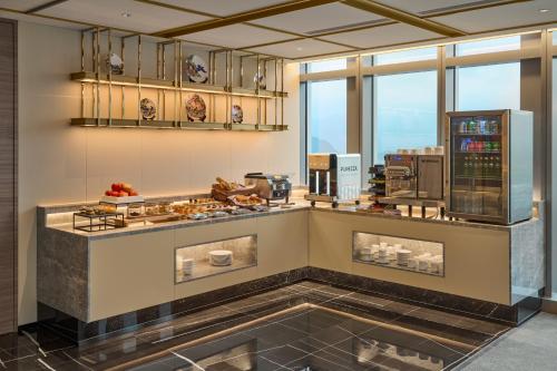 a kitchen with a counter with food on it at Grand HiLai Taipei in Taipei