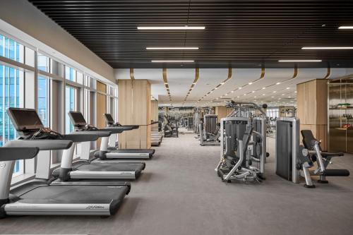 a gym with rows of treadmills and machines at Grand HiLai Taipei in Taipei