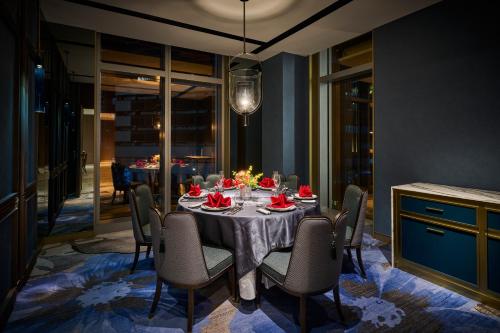 a dining room with a table with chairs and a dining room at Grand HiLai Taipei in Taipei