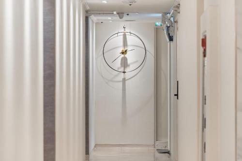 a hallway with a clock on the wall at Snowflower Guesthouse in Seoul