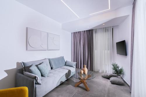 a living room with a couch and a glass table at Luxury Villa Muse Calliope in Matala