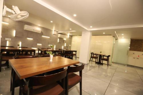- une salle à manger avec une table et des chaises en bois dans l'établissement Hotel Ambica Palace AIIMS New Delhi - Couple Friendly Local ID Accepted, à New Delhi