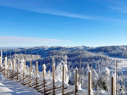 a fence covered in snow on top of a mountain at 10 person holiday home in NESBYEN-By Traum in Nesbyen