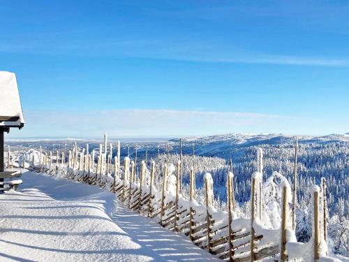 a fence covered in snow next to a mountain at 10 person holiday home in NESBYEN-By Traum in Nesbyen