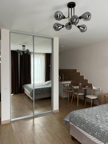 a bedroom with a bed and a dining room at ЖК «Сонячний квартал» in Solochin