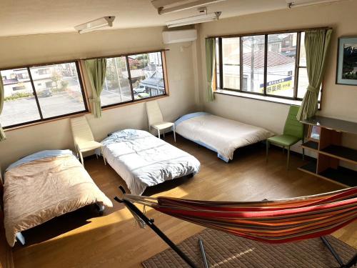 a room with two beds and a hammock in it at 今市STAY - NIKKO private house rental only 5 min to station in Nikko