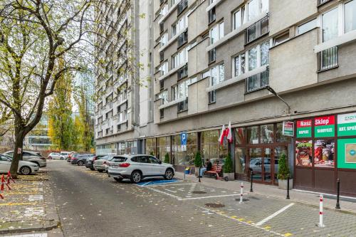 a city street with cars parked in front of a building at Apartament Grzybowska Premium by Your Freedom in Warsaw