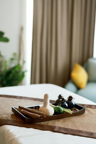 a tray with chopsticks and other items on a bed at Crowne Plaza Phu Quoc Starbay by IHG in Phu Quoc
