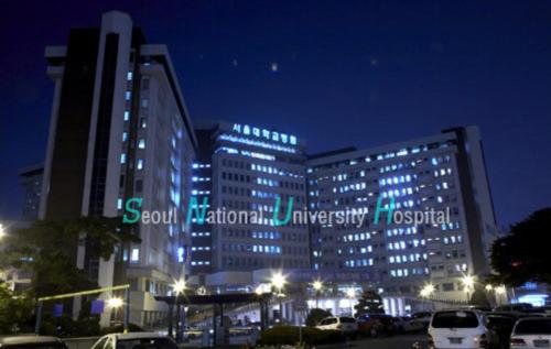 a large building with blue lights in a parking lot at Cony house in Seoul