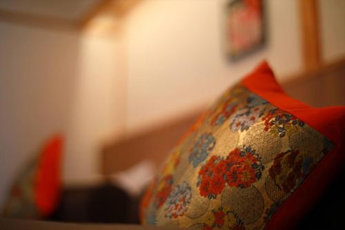 a close up of a couch with a floral pillow at 海のほてる　いさば in Numazu