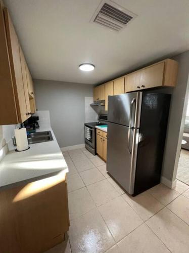 a kitchen with a stainless steel refrigerator in it at Busch Gardens Bliss Retreat 1 Bedroom in Tampa