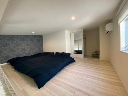 a bedroom with a bed on a wooden floor at Shibuya Stay Tokyo A204 in Tokyo