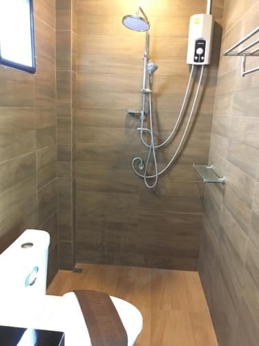 a shower in a bathroom with a toilet and a sink at Baan Fran Sim Da in Bang Tao Beach
