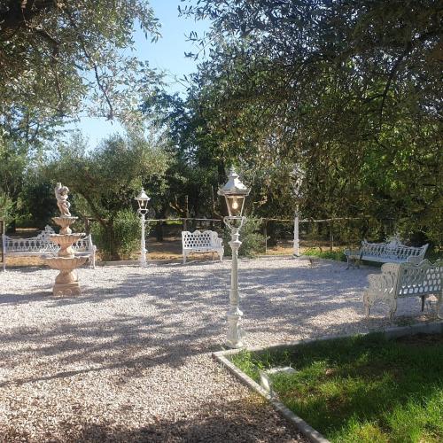a park with benches and a fountain and a street light at Tenuta Oliva in Fisciano