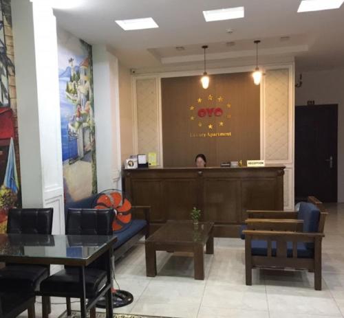 a person sitting in a waiting room at a waiting desk at Luxury Hotel - 50/3 Trường Sơn, Q. Tân Bình - by Bayhostel in Ho Chi Minh City
