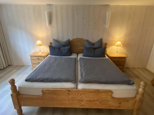 a bedroom with two beds with blue pillows at Fievfoten EG in Borkum