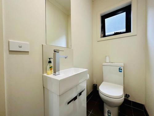 a bathroom with a white sink and a toilet at Mt Waverley Spacious 2br2ba Parking Wifi Balcony in Mount Waverley