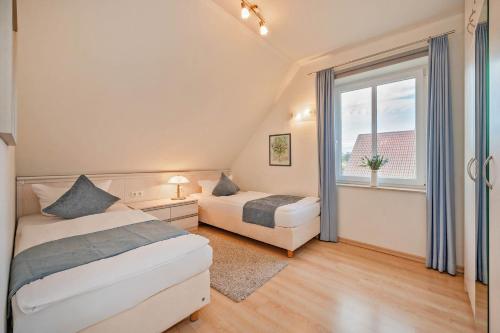 Ένα ή περισσότερα κρεβάτια σε δωμάτιο στο Ferienhaus am Wolgastsee