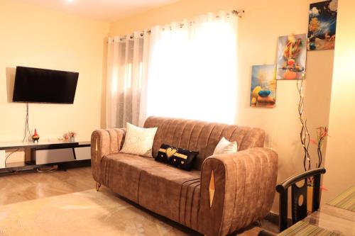 a living room with a couch and a television at GP homes in Nyeri