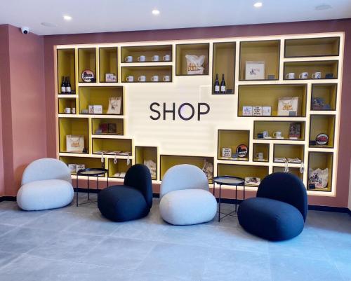 a shop with blue and white chairs and shelves at Aparthotel Colombo Roma in Rome