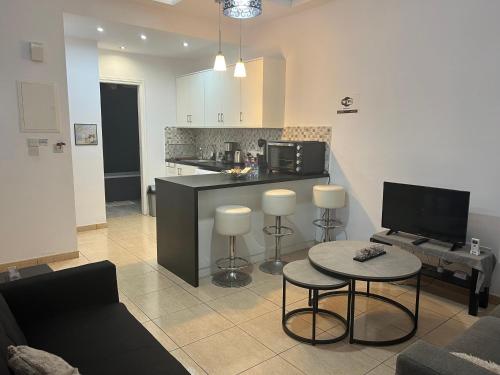 a living room with a kitchen and a table and chairs at Charalambous Apartment in Paphos